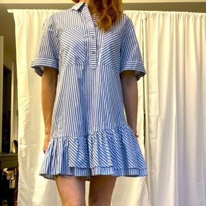 Pinstripe dress with front pocket and asymmetrical drop-hem bottom ruffle